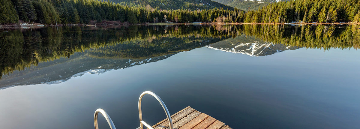 Early morning sunlight on the dock at Lost Lake in Whistler, Bri
