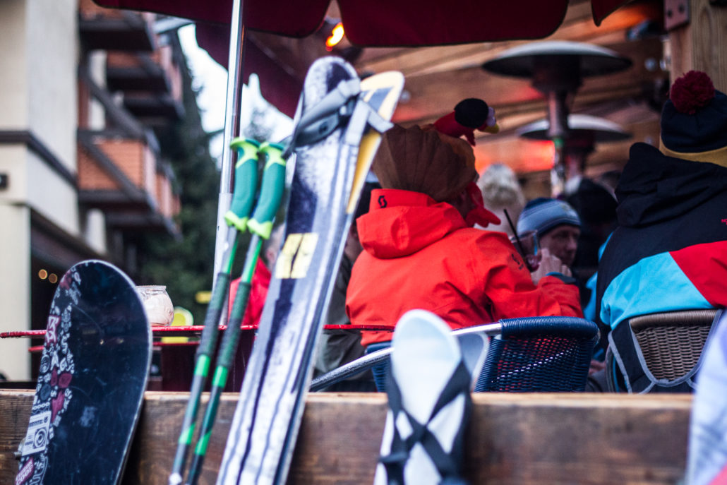 photo of skis leaning against the patio of a bar in whistler, bc. 
