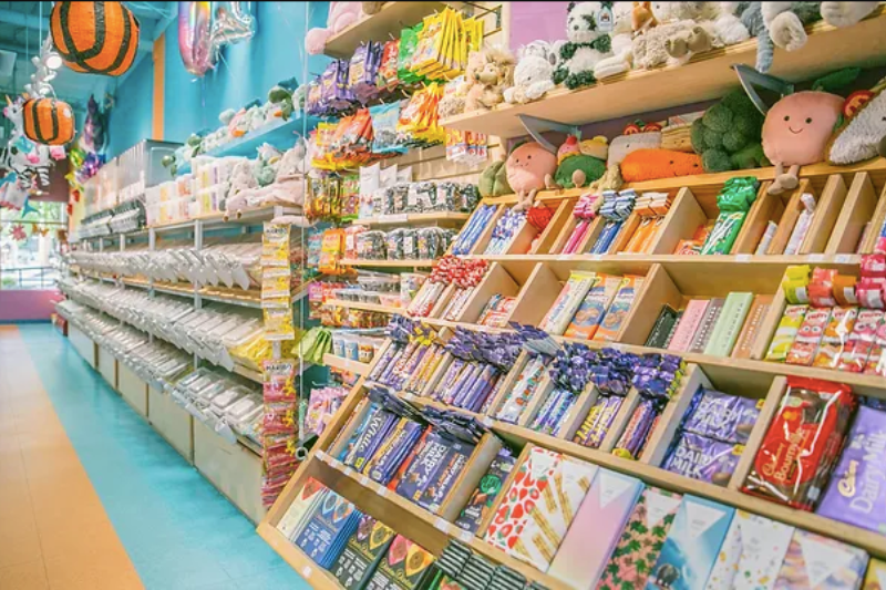 Candy store filled with shelves of candy and chocolate and toys