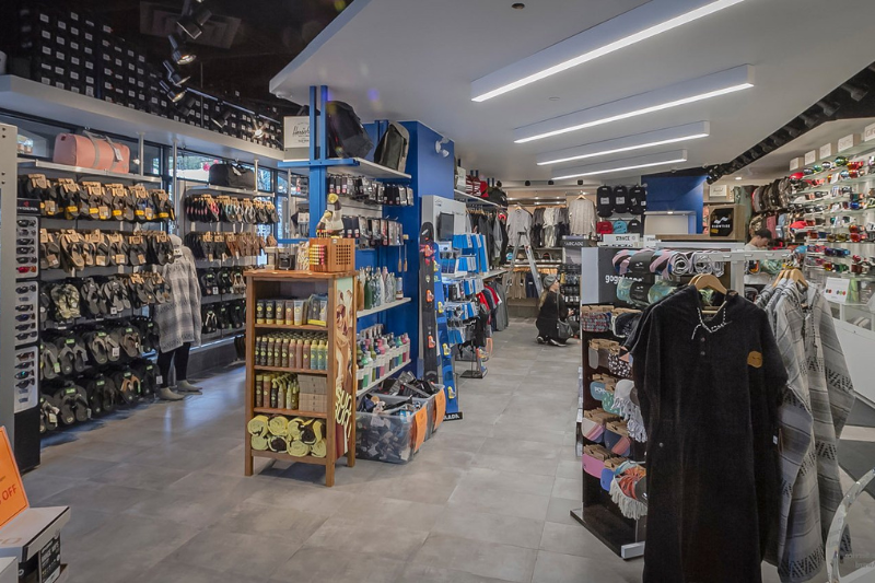 Inside of a winter gear shop selling gloves, goggles, snow clothes and sunglasses